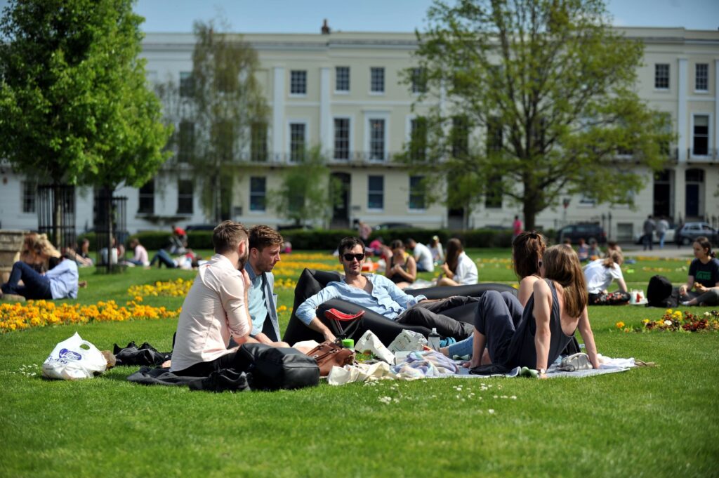 A group of people relaxing on the grass at Imperial Gardens