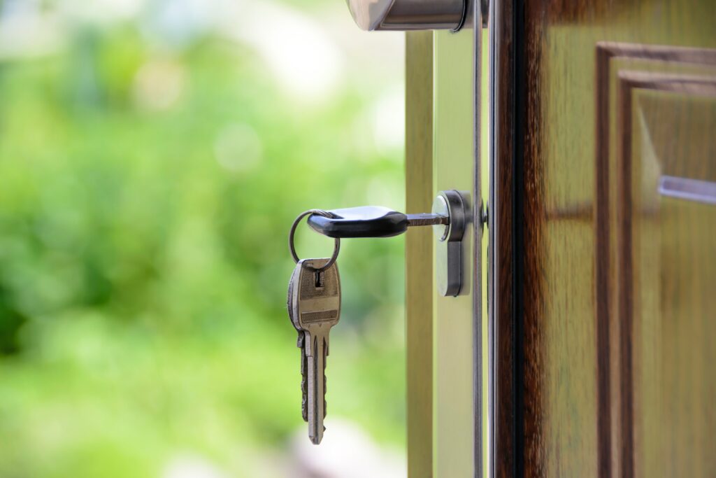 Keys inside the lock of a door. The door is open